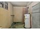 View of the basement showing the water heater, flooring, and walls needing repair at 922 Nashville Rd, Rocky Mount, NC 27803
