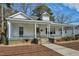 Charming home featuring a covered front porch with white pillars and a welcoming entrance at 922 Nashville Rd, Rocky Mount, NC 27803