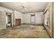 Spacious living room with a brick fireplace, ceiling fan, and bright windows at 922 Nashville Rd, Rocky Mount, NC 27803