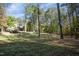 Large backyard backing up to wooded area with mature trees and a covered patio visible at 10004 Liana Ln, Raleigh, NC 27613