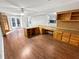 Spacious basement with wood-look floors, built-in desk, shelving, and access to the backyard at 10004 Liana Ln, Raleigh, NC 27613