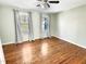 Bedroom with wood floors and two windows providing an abundance of natural light at 10004 Liana Ln, Raleigh, NC 27613