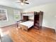 Bedroom with a bunk bed, hardwood floors and natural light from two windows at 10004 Liana Ln, Raleigh, NC 27613