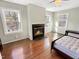 Bright room with hardwood floors, fireplace, and natural light from multiple windows at 10004 Liana Ln, Raleigh, NC 27613