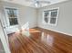 Bedroom with hardwood floors and natural light from two windows at 10004 Liana Ln, Raleigh, NC 27613