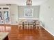 Bright dining room features a dining table with seating for six, large windows, and hardwood floors at 10004 Liana Ln, Raleigh, NC 27613