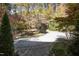 Circular driveway surrounded by trees and landscaping providing ample parking space at 10004 Liana Ln, Raleigh, NC 27613