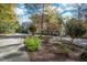 Beautiful home with a lush front yard and a long driveway, surrounded by trees at 10004 Liana Ln, Raleigh, NC 27613