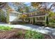 Charming home with a covered front porch, beautiful landscaping, and a long drive at 10004 Liana Ln, Raleigh, NC 27613