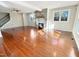 Spacious living room with stone fireplace, hardwood floors, neutral paint, and large windows at 10004 Liana Ln, Raleigh, NC 27613