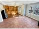 Living room with tiled floors, built-in shelving, and natural light from windows at 10004 Liana Ln, Raleigh, NC 27613