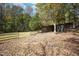 Outbuilding with adjacent fenced in area, suitable for storage or other outdoor needs at 10004 Liana Ln, Raleigh, NC 27613