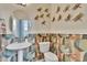 Chic half-bathroom with unique patterned walls, pedestal sink, and decorative accents create a stylish space at 10014 Secluded Garden Drive Rd # 185, Apex, NC 27523