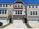 Charming townhouse exteriors featuring a mix of brick, siding, and stylish architectural details at 10014 Secluded Garden Drive Rd # 185, Apex, NC 27523