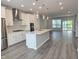 Open-concept kitchen and living area with recessed lighting, white cabinets, and stainless appliances at 10018 Secluded Garden Drive Rd # 187, Apex, NC 27523