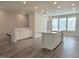 Bright living room with recessed lighting, an island with sink, and large windows at 10018 Secluded Garden Drive Rd # 187, Apex, NC 27523