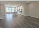 Spacious living room with recessed lighting, open to the kitchen, and large windows at 10018 Secluded Garden Drive Rd # 187, Apex, NC 27523