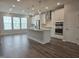 Spacious open-concept kitchen with a large island, stainless steel appliances, and hardwood floors at 10020 Secluded Garden Drive Rd # 188, Apex, NC 27523