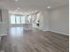 Open-concept living space with luxury vinyl plank flooring, flowing into the kitchen and dining area at 10020 Secluded Garden Drive Rd # 188, Apex, NC 27523