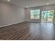 Bright living room features luxury vinyl plank flooring and a sliding glass door to the outdoor patio at 10020 Secluded Garden Drive Rd # 188, Apex, NC 27523