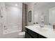 A well-lit bathroom features a shower-tub combo, a modern sink, and a stylish, black vanity at 1003 Red Roses Ave, Durham, NC 27703