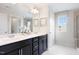 Modern bathroom with a double sink vanity, sleek fixtures, and a large mirror at 1003 Red Roses Ave, Durham, NC 27703