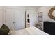 Bedroom with a double-door closet, accent wall art, and soft, neutral tones at 1003 Red Roses Ave, Durham, NC 27703