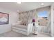 The bedroom has a daybed adorned with decorative wallpaper and natural light from the side window at 1003 Red Roses Ave, Durham, NC 27703