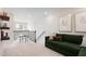 Bright loft features a cozy green sofa and a charming table set near the window, great for relaxing or reading at 1003 Red Roses Ave, Durham, NC 27703