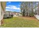 Home featuring a backyard with wood deck and mature trees creating privacy at 102 Switchback St, Knightdale, NC 27545
