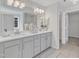 Bright bathroom featuring double sinks, a large mirror, and stylish lighting fixtures at 102 Switchback St, Knightdale, NC 27545