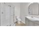 Well-lit bathroom featuring a walk-in shower, modern vanity, and neutral color scheme at 102 Switchback St, Knightdale, NC 27545