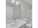 Well-lit bathroom features a large mirror, sleek vanity, and shower-tub combo at 102 Switchback St, Knightdale, NC 27545