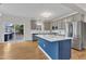 Modern kitchen featuring stainless steel appliances, a center island, and access to the deck at 102 Switchback St, Knightdale, NC 27545