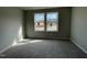 Bright bedroom with large windows offering natural light and views of the surrounding neighborhood at 103 Oakfield Trace Dr, Four Oaks, NC 27524