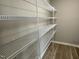 Walk-in closet with vinyl floor and wire shelving for storage and organization at 103 Oakfield Trace Dr, Four Oaks, NC 27524