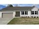 Charming single-story home with a manicured lawn, attached garage, and neutral color scheme at 103 Oakfield Trace Dr, Four Oaks, NC 27524
