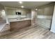 Bright, open kitchen featuring an island with sink, granite countertops, and stainless appliances at 103 Oakfield Trace Dr, Four Oaks, NC 27524
