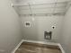 Dedicated laundry room with modern vinyl flooring and hookups for appliances at 103 Oakfield Trace Dr, Four Oaks, NC 27524