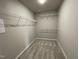 Spacious walk-in closet with carpeted floors and multiple wire shelving units for ample storage at 103 Oakfield Trace Dr, Four Oaks, NC 27524