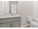 Modern bathroom with sleek vanity, light gray cabinets, and a toilet at 104 Pisgah St, Sanford, NC 27330