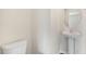 Powder room features a pedestal sink and a toilet at 104 Pisgah St, Sanford, NC 27330