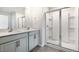 Bathroom with double vanity, framed mirror, glass shower door, and chrome fixtures exudes functional elegance at 104 Pisgah St, Sanford, NC 27330