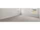 Bright bedroom featuring neutral walls, gray carpet and two sunny windows at 104 Pisgah St, Sanford, NC 27330