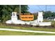 Galvins Ridge entrance sign with brick columns, wooden beam, and landscaped flower beds at 104 Pisgah St, Sanford, NC 27330