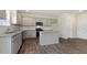Contemporary kitchen featuring gray cabinets, granite counters, and center island at 104 Pisgah St, Sanford, NC 27330