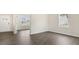 Open-concept area featuring wood-look flooring, an adjacent room, and a bright window at 104 Pisgah St, Sanford, NC 27330