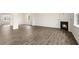 Open living room area featuring a fireplace, neutral walls, and luxury vinyl plank flooring at 104 Pisgah St, Sanford, NC 27330