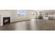 Open living space featuring luxury vinyl plank flooring, fireplace, and open access to the kitchen at 104 Pisgah St, Sanford, NC 27330