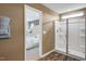 Bright bathroom featuring a walk-in shower with glass doors and a glimpse into an adjacent bedroom at 104 Siebold St, Garner, NC 27529